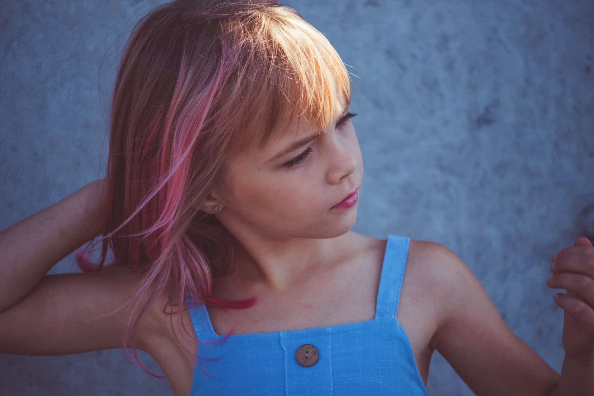 girl portrait . Outdoor portrait of cute little girl in summer day. girl with pink hair. Child 7-8