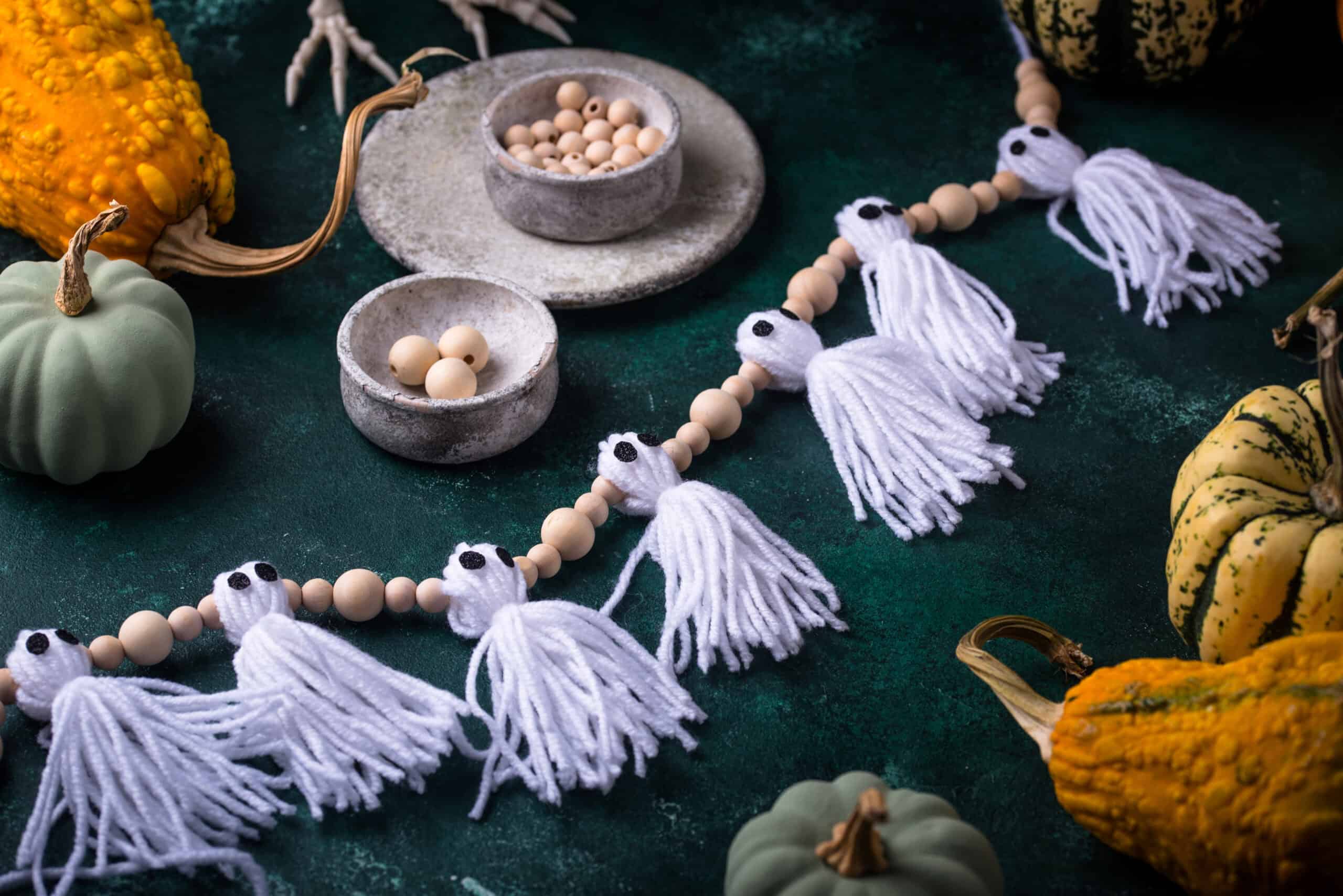 DIY craft garland for Halloween in shape of ghost. October handmade decor.