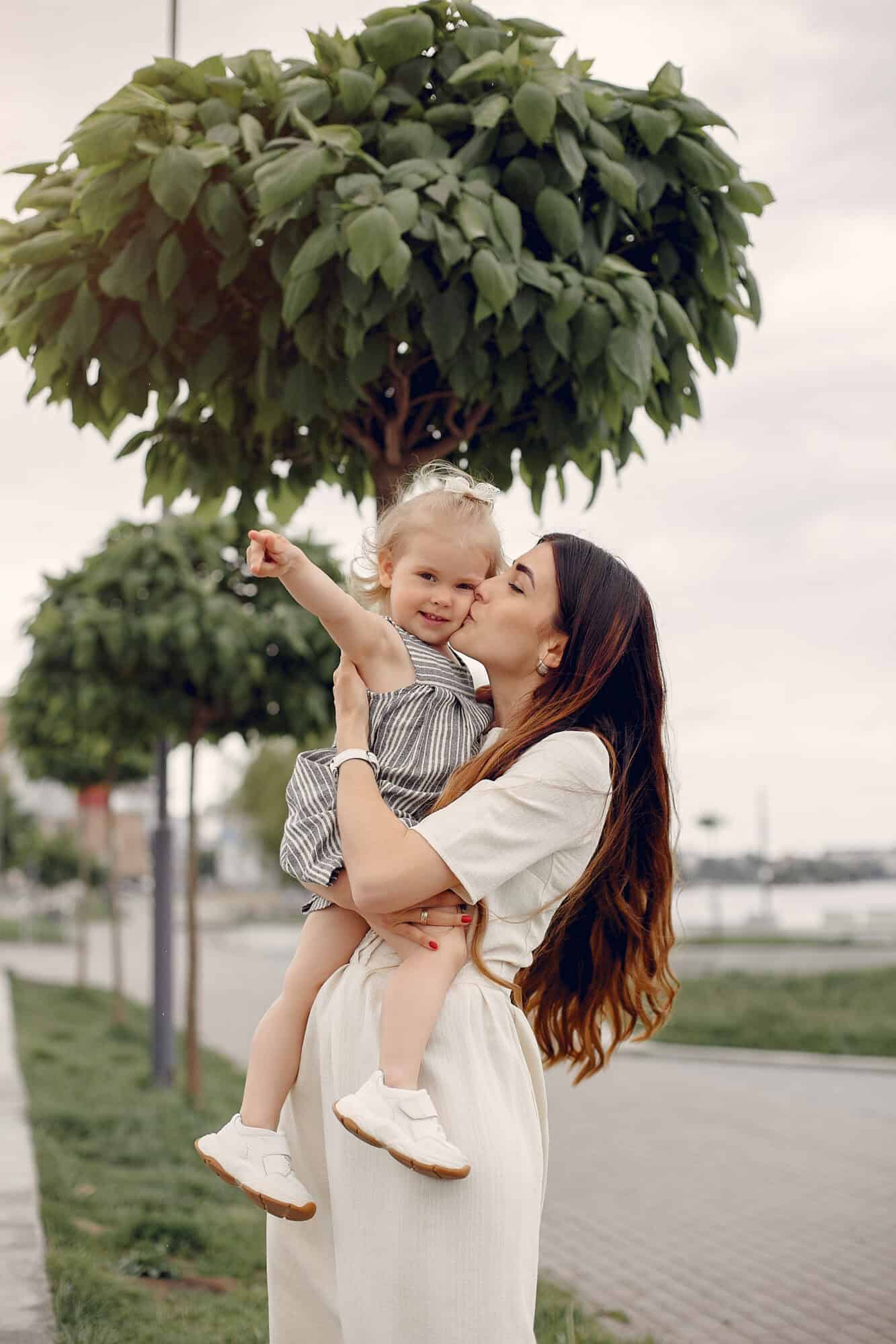 Mother with daughter. Family in a park. Cute little girl