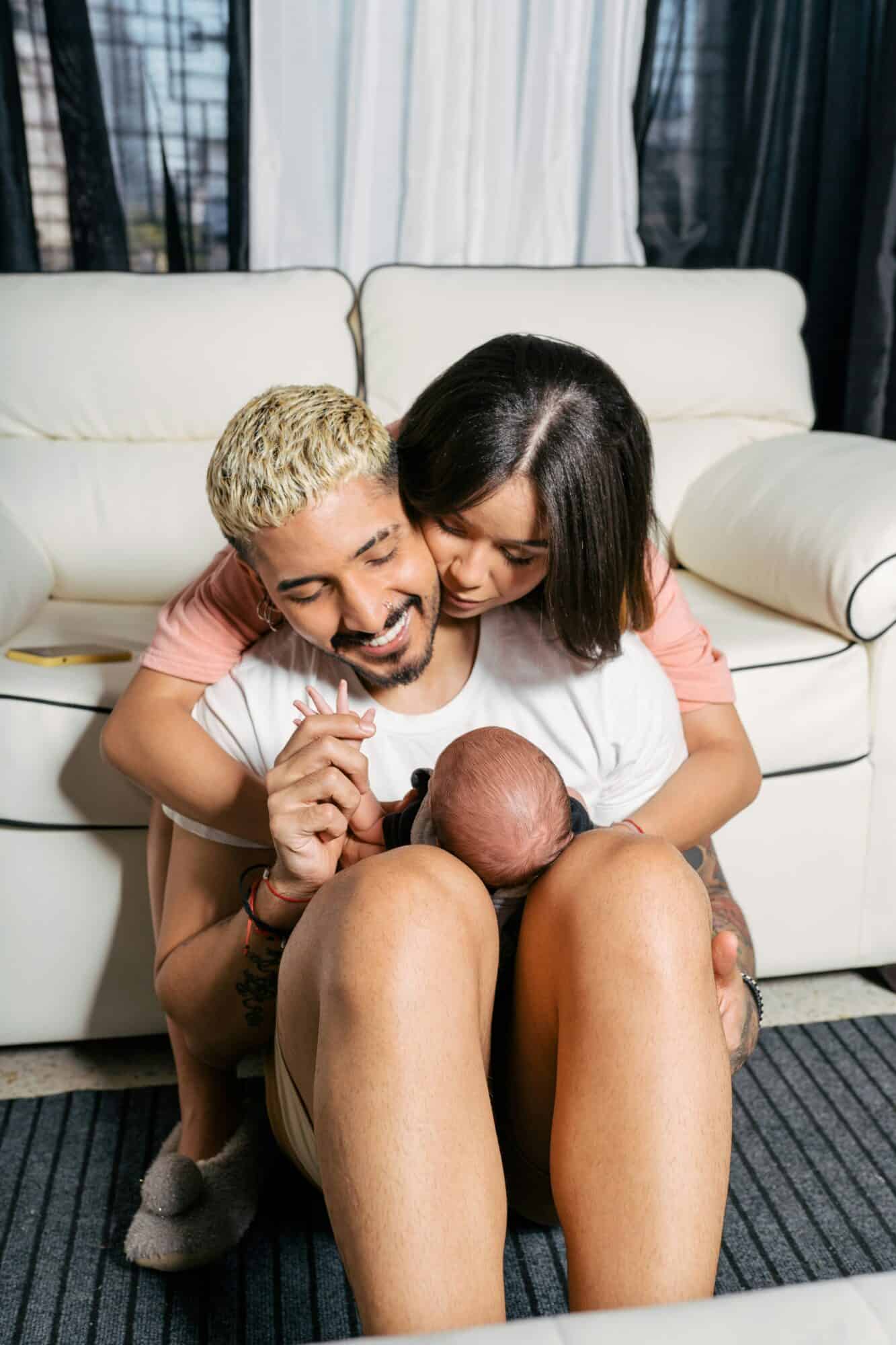 latin couple with their newborn baby at home