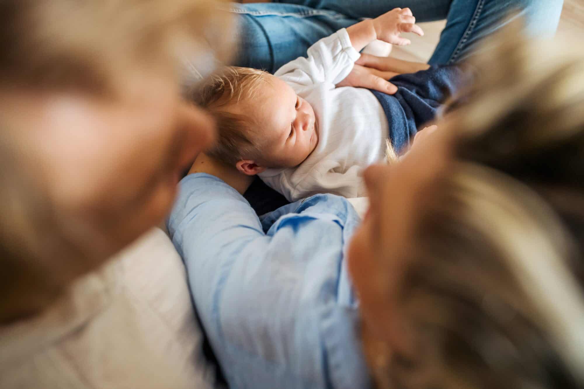 grandparents holding newborn baby