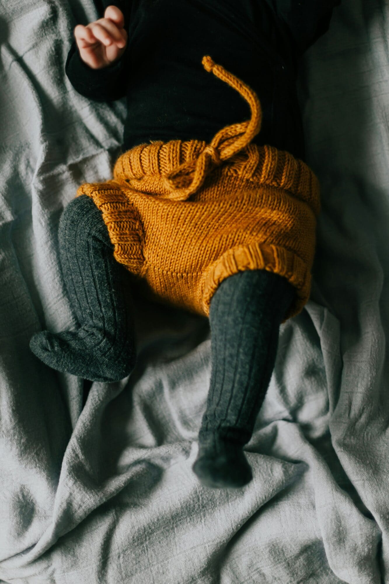 trendy newborn baby laying in crib